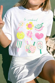 White polyester t-shirt with playful pickleball and floral graphic print and text.