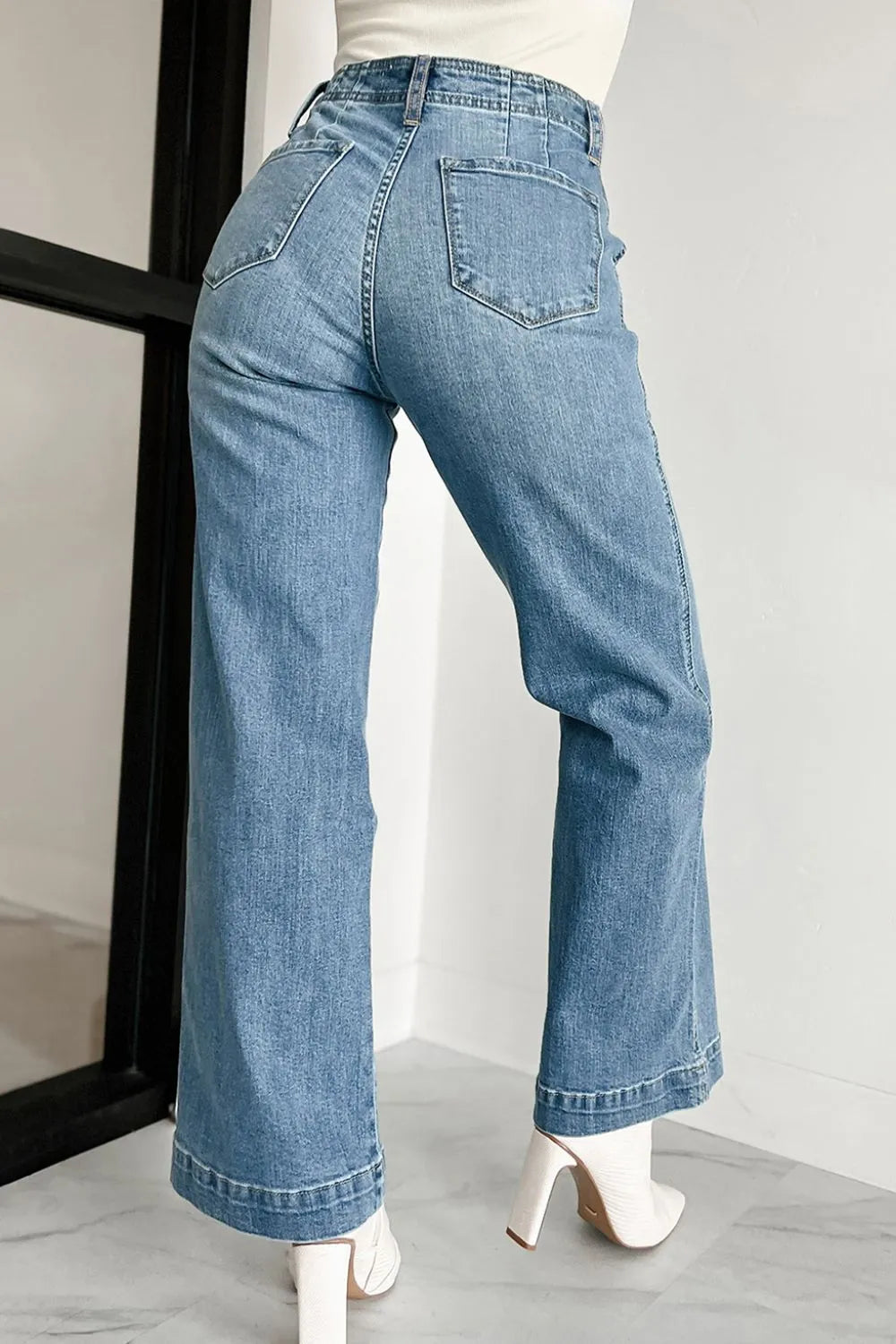 Button-fly wide-leg denim trousers in medium wash, featuring a high waist and flared hem.