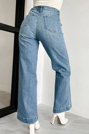 Button-fly wide-leg denim trousers in medium wash, featuring a high waist and flared hem.