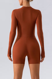 Sculpted performance romper in caramel with zip detail, long sleeves and short legs.
