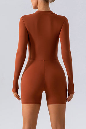 Sculpted performance romper in caramel with zip detail, long sleeves and short legs.