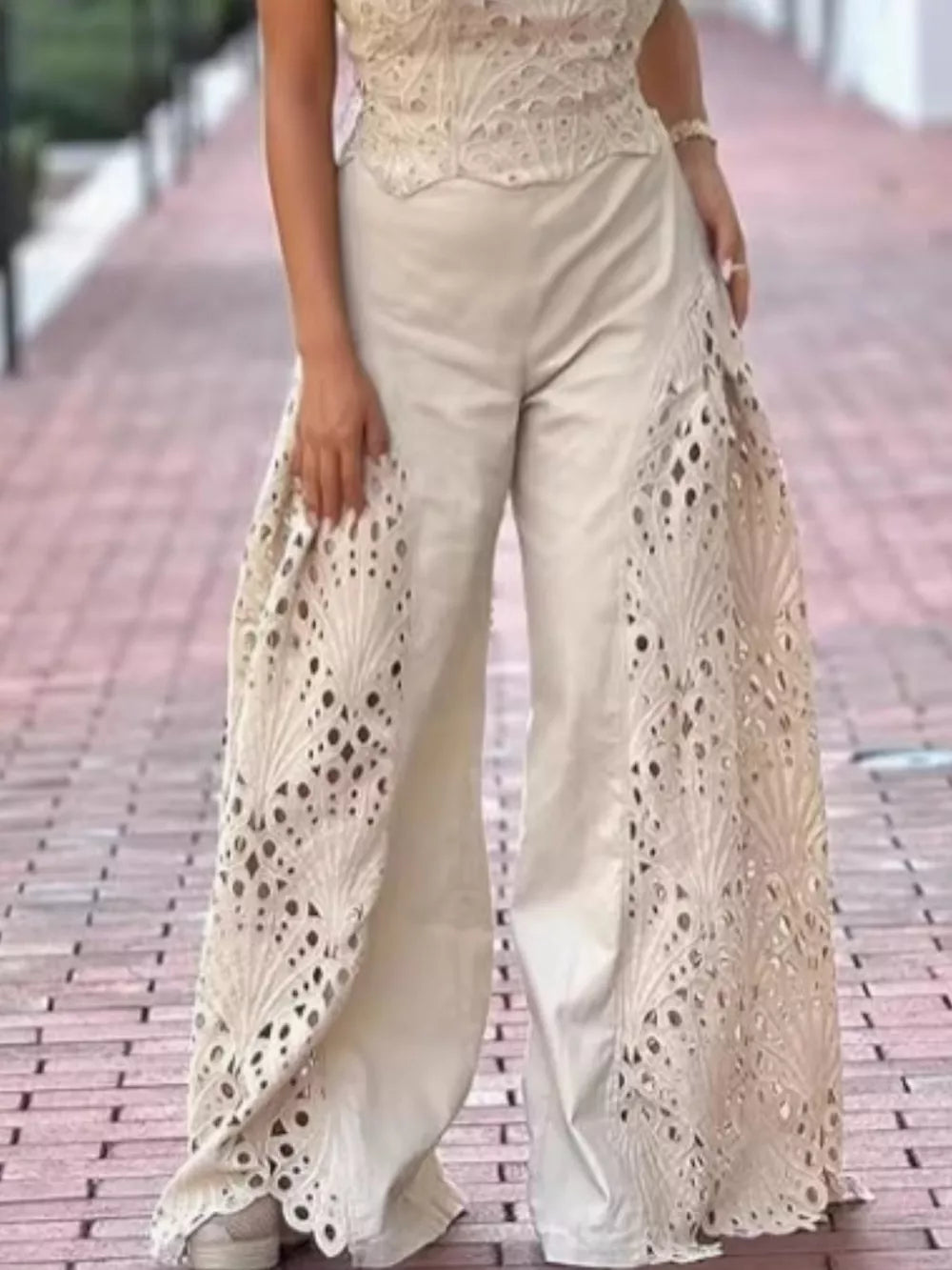 Apricot openwork two-piece ensemble with intricate lace details on wide-leg pants.