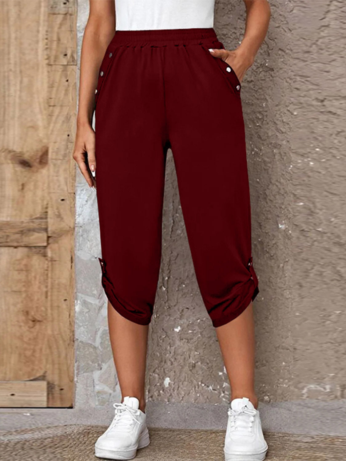Burgundy culottes with button details and cinched hems, cropped length.