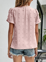 Pink textured puff sleeve dot blouse with short sleeves and a V-neck.