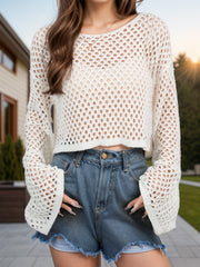 Cream open-knit cropped sweater with bell sleeves and a relaxed fit.