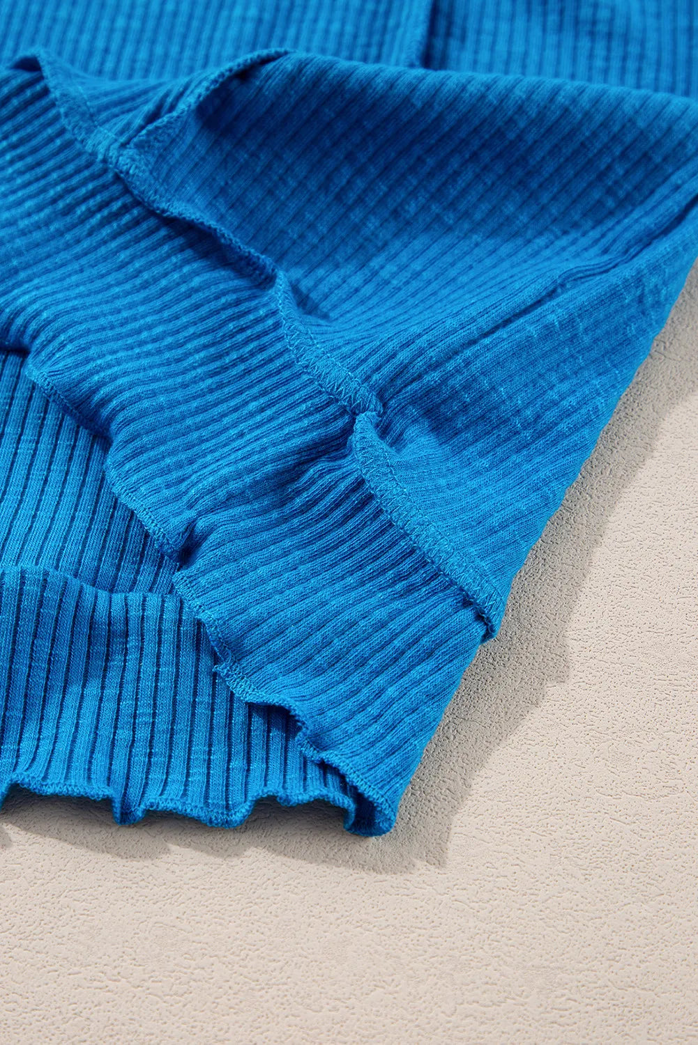 Textured sky blue thermal top with cutout neckline detail.
