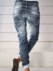 Dark blue cuffed button-fly jeans with distressed detailing and a relaxed fit.