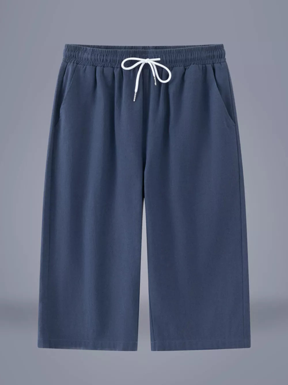 Relaxed fit cropped sweatpants in dark blue with drawstring waist and side pockets.