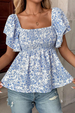 Floral ruffled sleeve babydoll shirt with smocked bodice and square neckline.