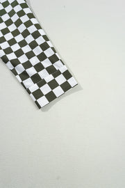 Olive and black checkered button-down shirt sleeve detail