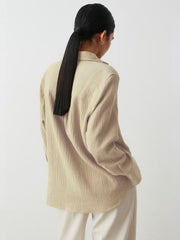 Beige textured cotton overshirt with relaxed fit and collared neckline.