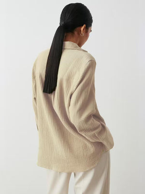 Beige textured cotton overshirt with relaxed fit and collared neckline.