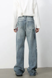 Ink-Blot Wide Leg Denim jeans in medium wash feature abstract paint splatters and artistic details.