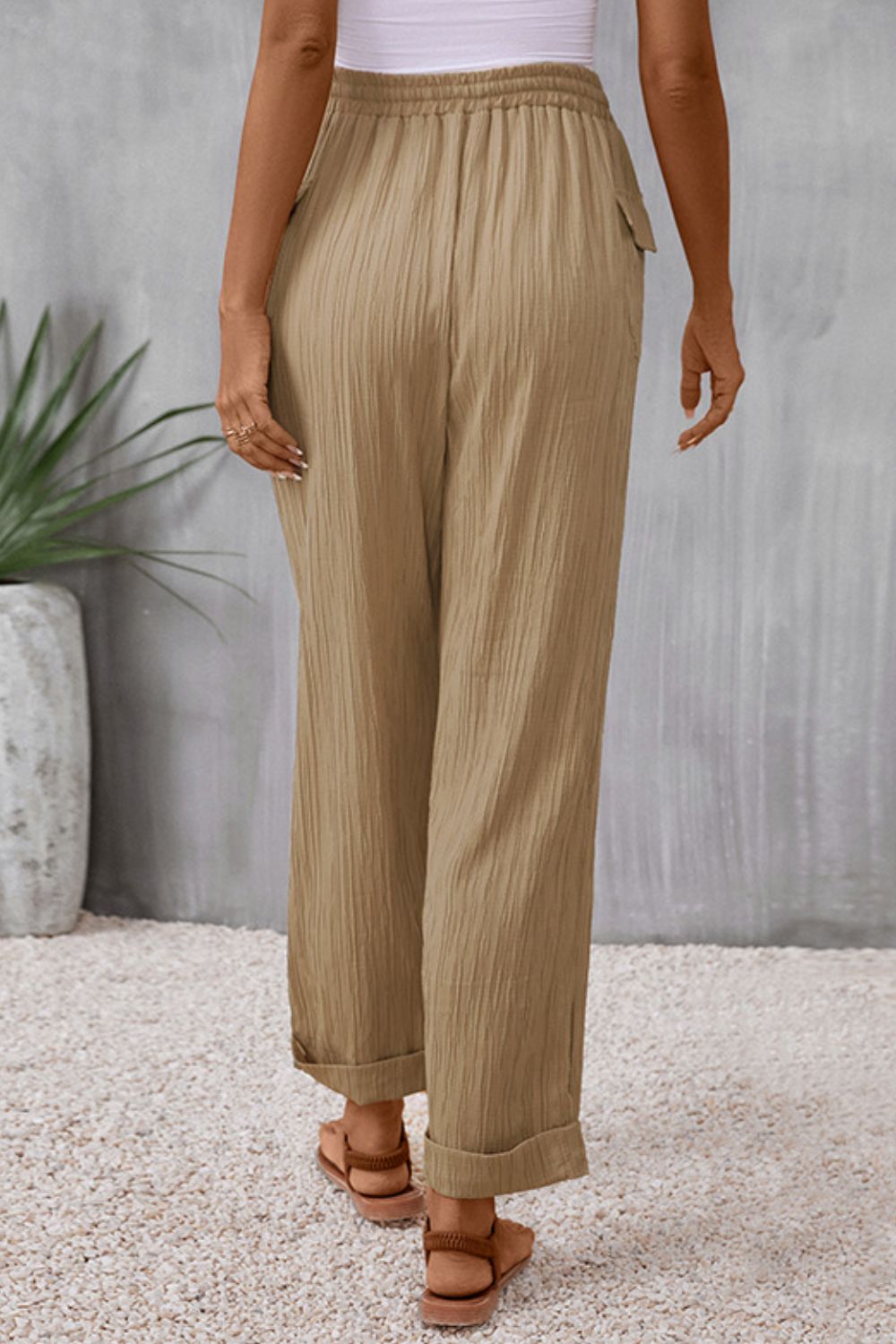 Khaki textured drawstring waistline trousers with cuffed hems.