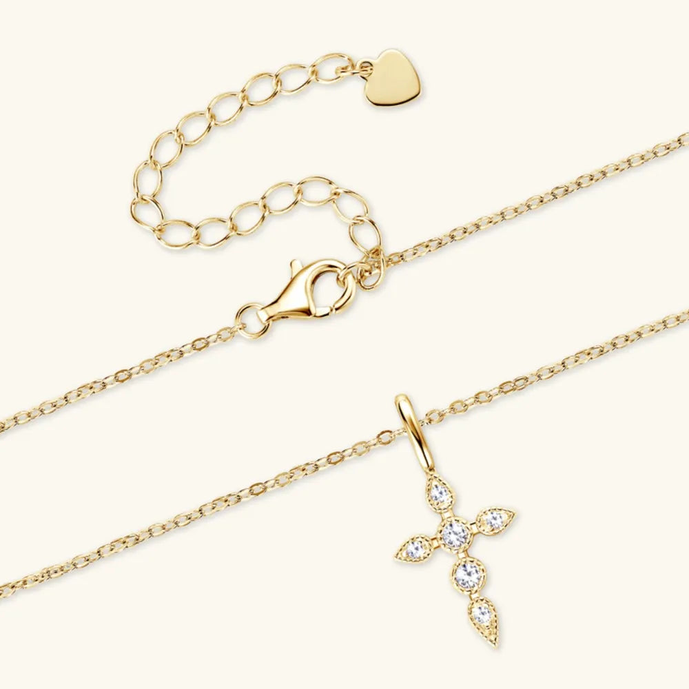 Gold diamond-set cross pendant necklace with adjustable chain and lobster clasp.