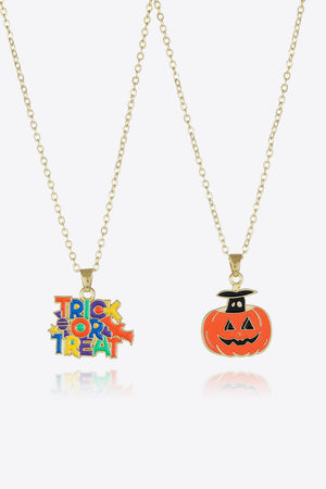 Spooky season enamel pendant necklaces with trick or treat text and jack-o-lantern charms.