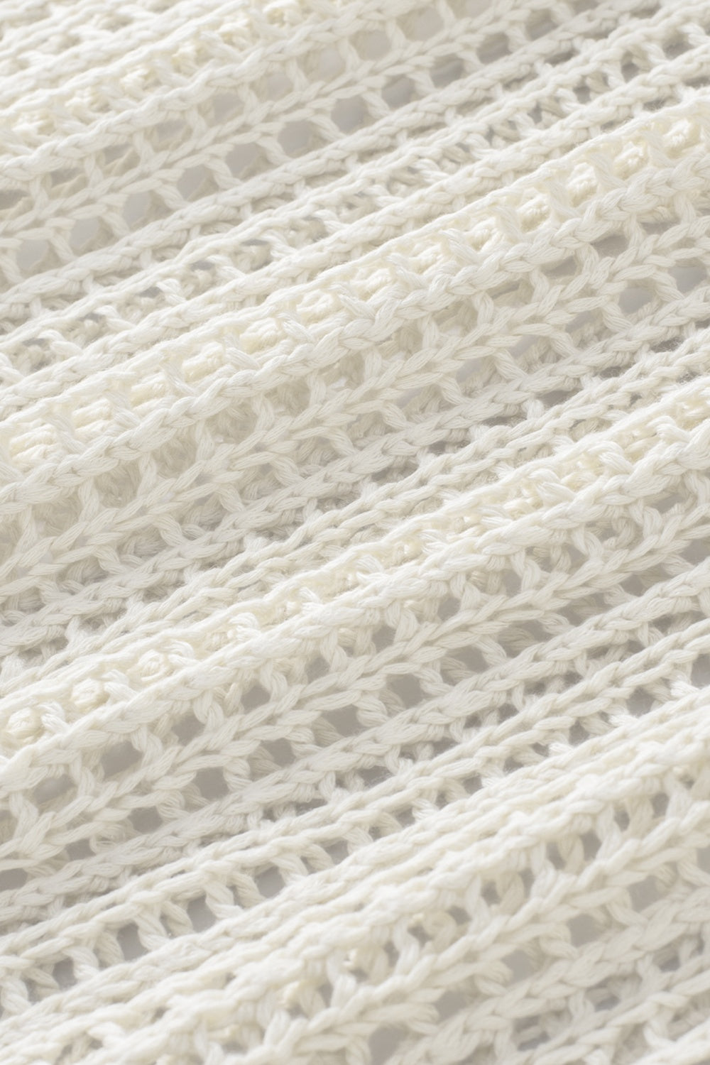 White open-knit acrylic slouchy shoulder cover-up with a relaxed fit.