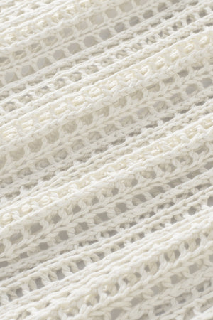 White open-knit acrylic slouchy shoulder cover-up with a relaxed fit.