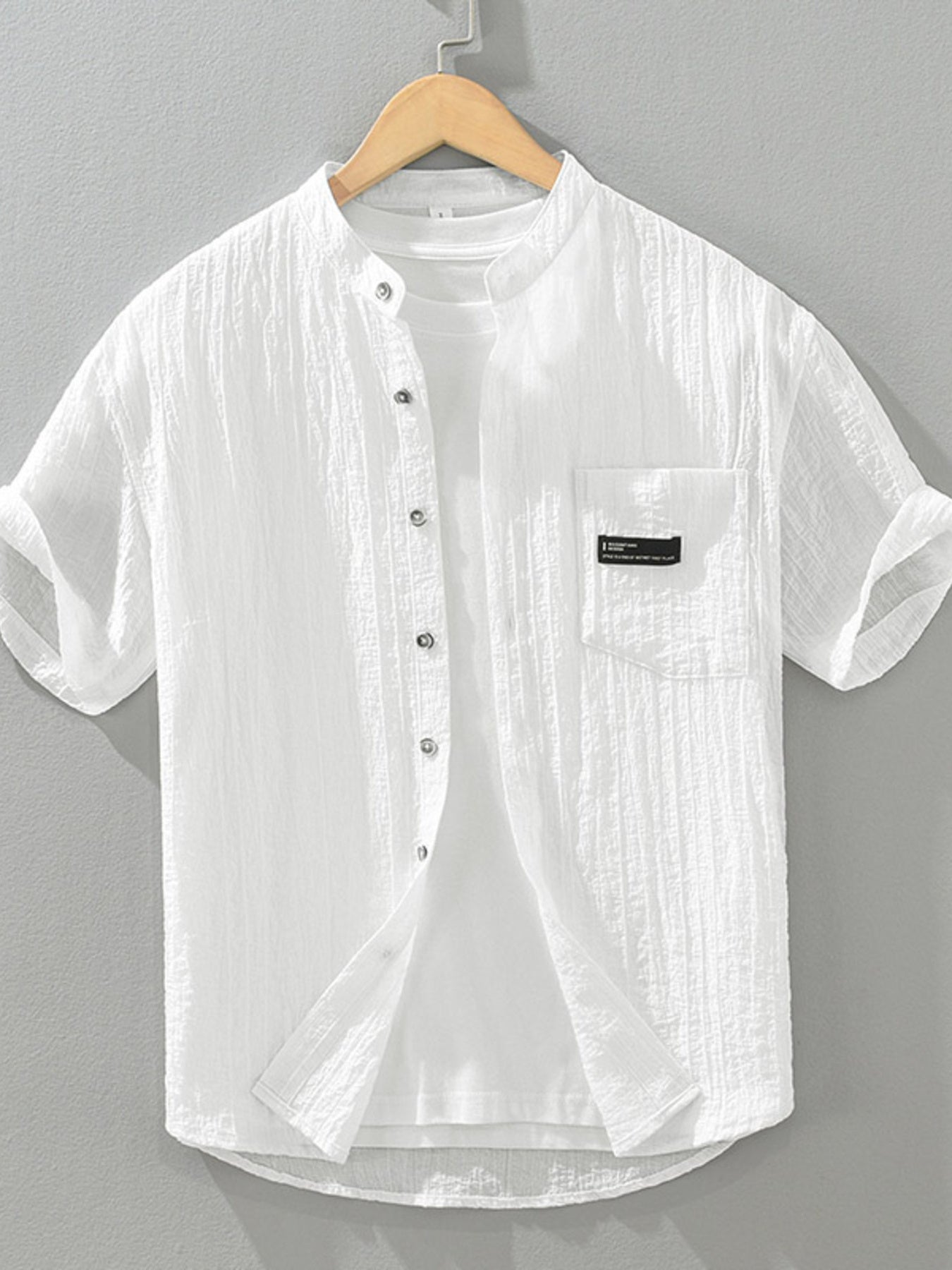 White textured cotton short sleeve button-up shirt with mandarin collar and chest pocket.