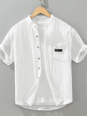 White textured cotton short sleeve button-up shirt with mandarin collar and chest pocket.
