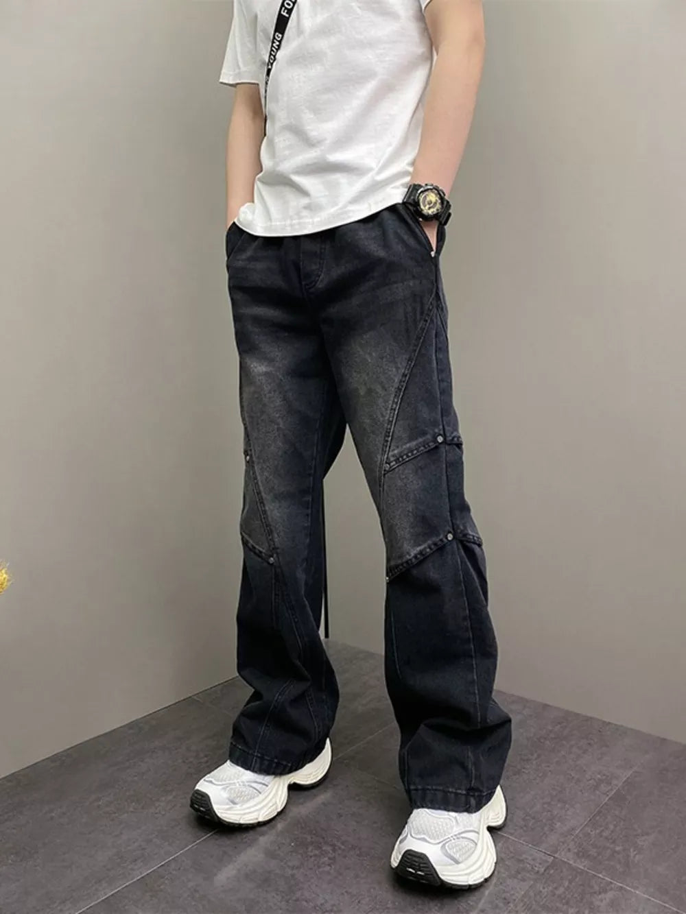 Distressed black wide-leg jeans for men with vintage wash and panel details.
