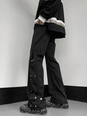 Men's black snap button loose fit sweatpants with adjustable ankle detail.