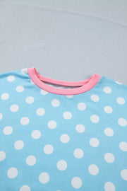 Pastel blue polka dot polyester pajama top with pink trim neckline