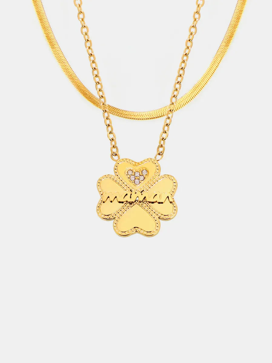 Gold layered necklaces with clover charm and crystal heart detail