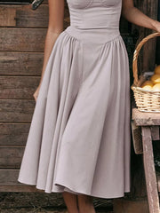 Light gray sweetheart midi dress with spaghetti straps and full skirt.