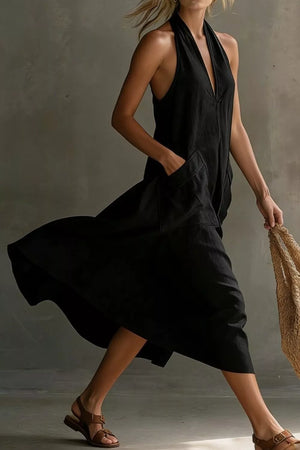 Black halter midi dress with pockets and a deep V-neckline.