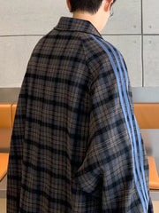 Oversized plaid long-sleeve shirt in black with blue stripes on the sleeves.