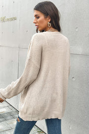 Beige waffle knit relaxed fit cardigan with pockets and button front.
