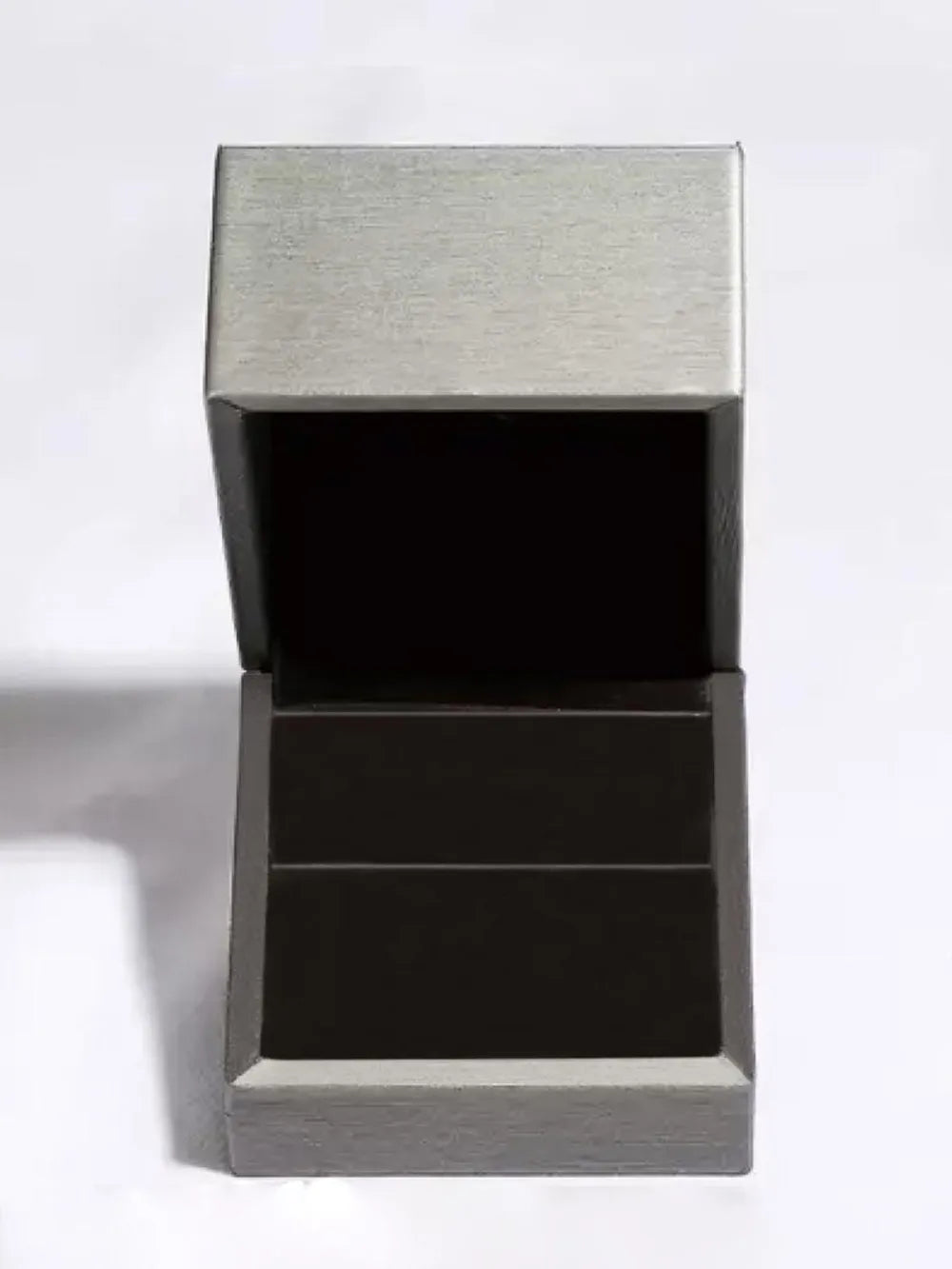 Silver ring box with open lid and black interior.