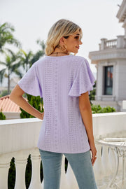 Lilac eyelet flounce sleeve crew neck top with intricate patterned cutouts.