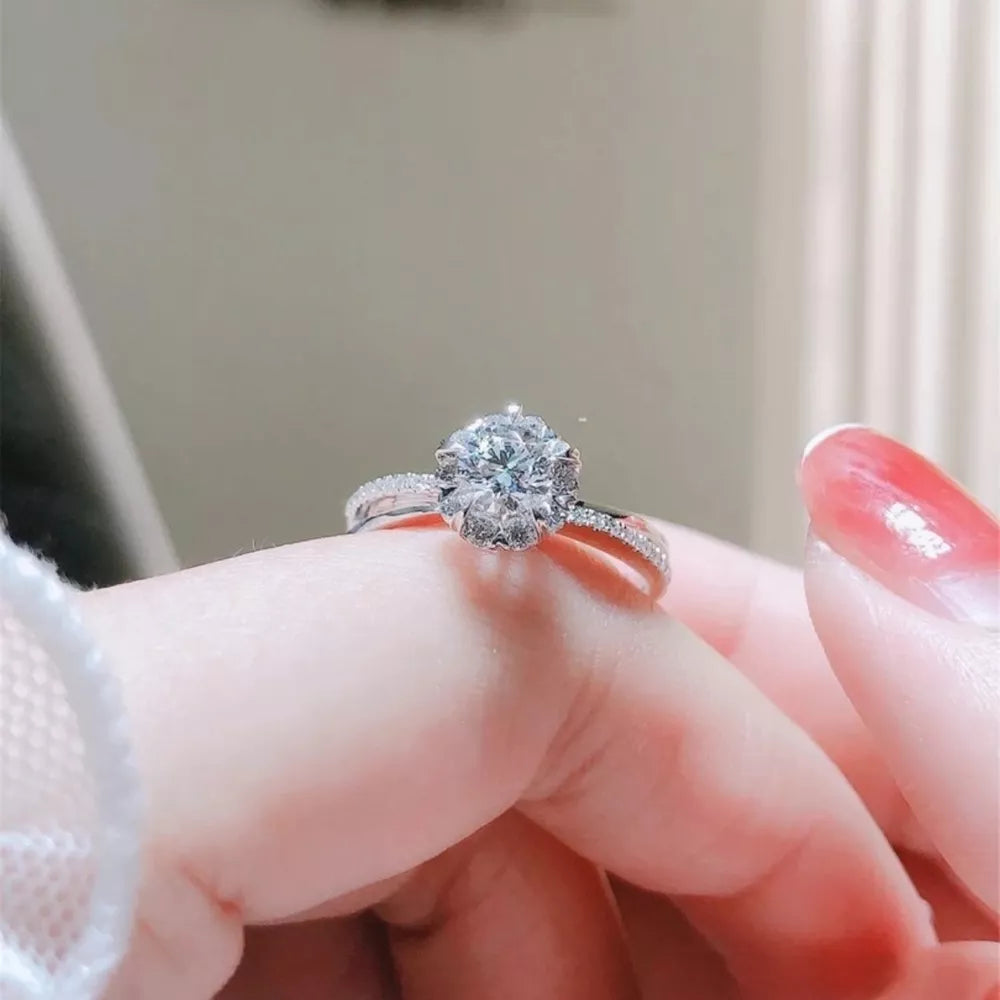 Brilliant moissanite ring in sterling silver with a halo of smaller stones.