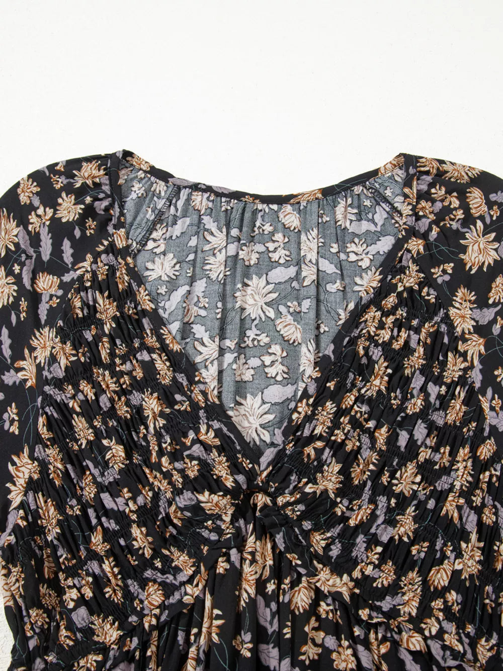Floral babydoll dress with deep V-neck and shirred bodice.