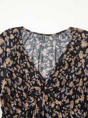 Floral babydoll dress with deep V-neck and shirred bodice.