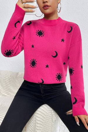 Hot pink acrylic knit sweater with mock neck and allover black sun, moon, and star print.