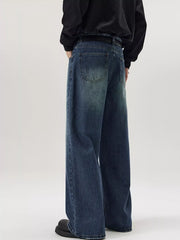 Men's wide-leg wash denim jeans in dark blue, relaxed fit, casual style.