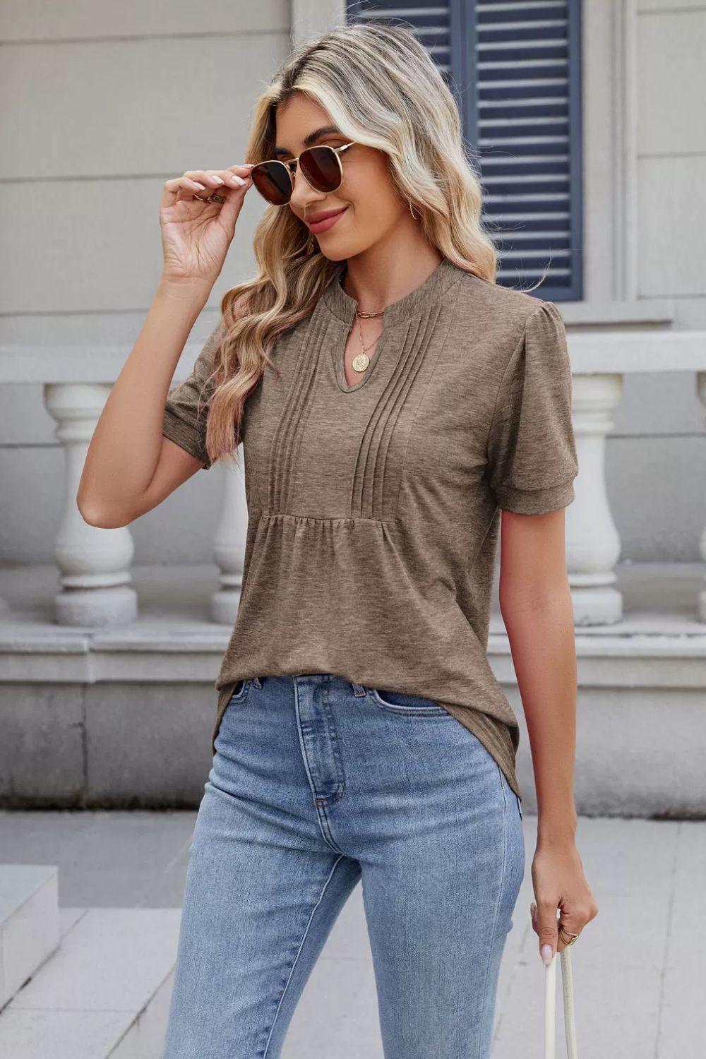 Pleated yoke keyhole tee in khaki with short sleeves and a relaxed fit.