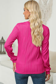 Textured wave crewneck pullover in cerise with long sleeves.