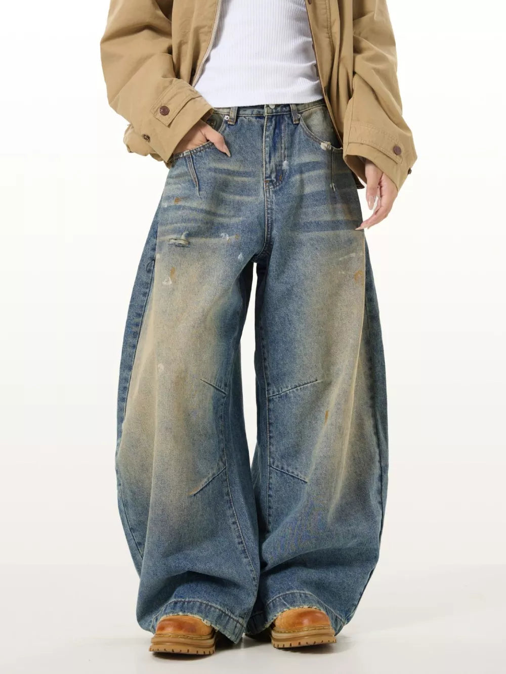 Men's vintage washed oversized wide leg jeans with distressed details and paint splatters.