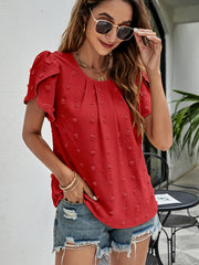 Red textured puff sleeve blouse with dot pattern and round neckline.
