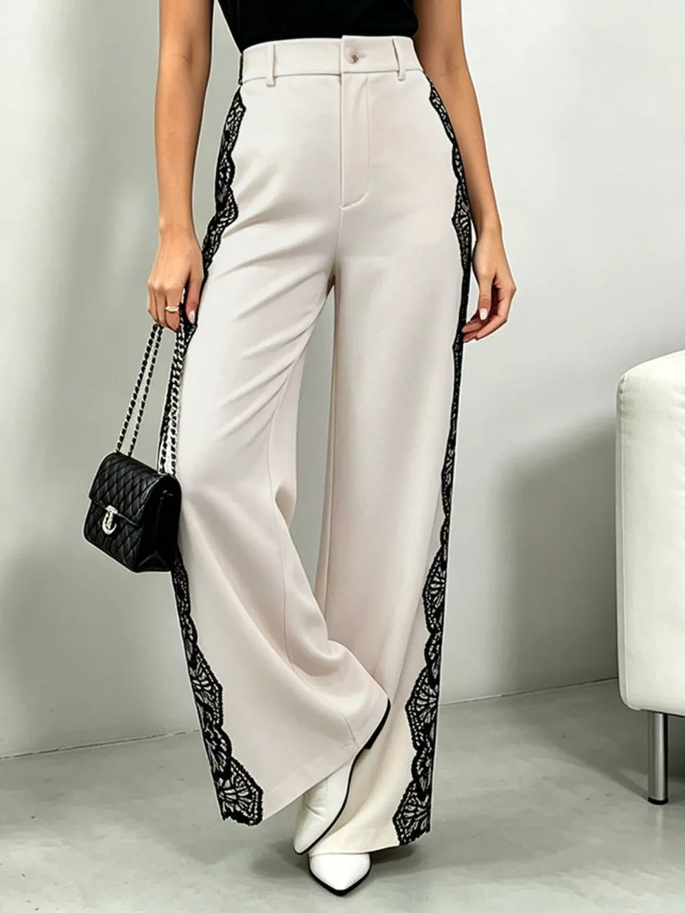 Lace-embellished high-waisted cream maternity pants with wide legs.