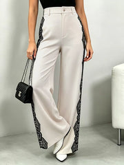 Lace-embellished high-waisted cream maternity pants with wide legs.