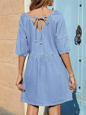 Light blue denim mini dress with puff sleeves and back tie detail