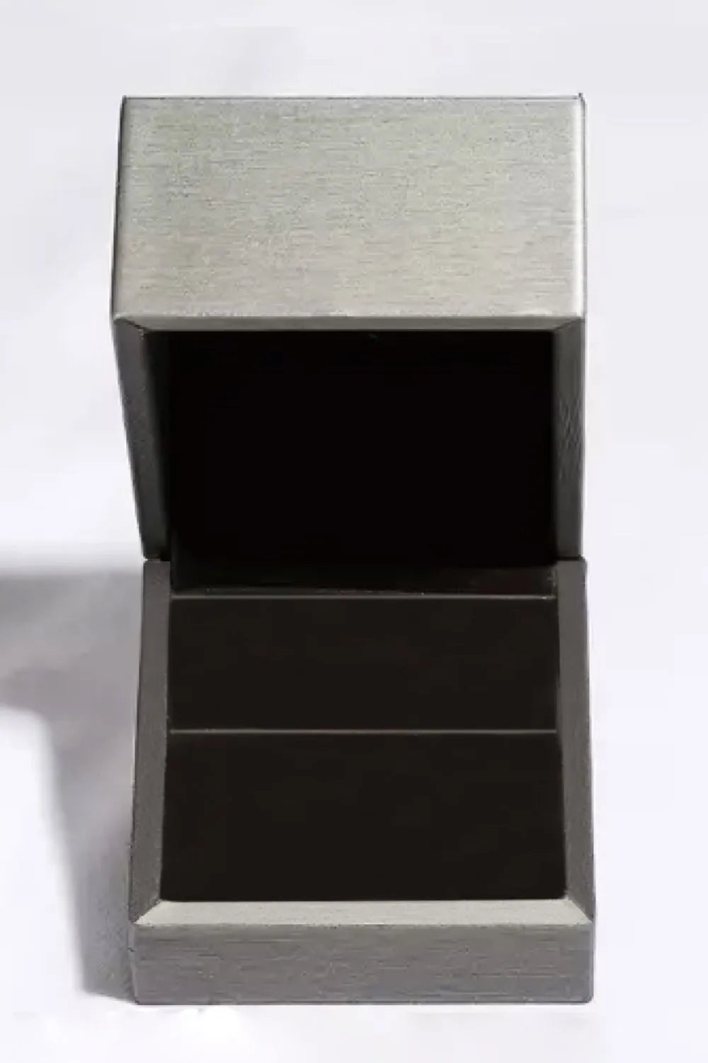 Open dark green ring box with silver-toned exterior