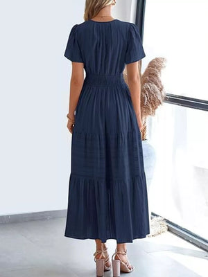 Dark blue ruched V-neck tiered midi dress with short sleeves and smocked waist.