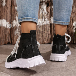 Black canvas lace-up high-top sneakers with white stitching and chunky sole.