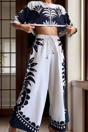 White crop top and palazzo pants set with monochrome botanical print and drawstring waist.